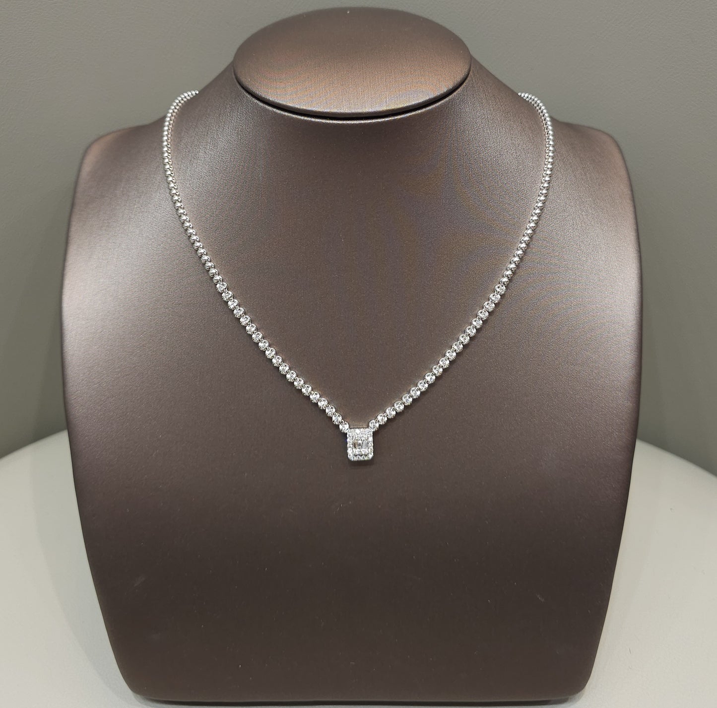The Majestic Emblem Diamond Necklace featuring a V-shape natural diamond necklace with double halo oval pendant crafted in 18K White Gold and optional GIA certified center diamond by S.Diamond Bangkok Thailand