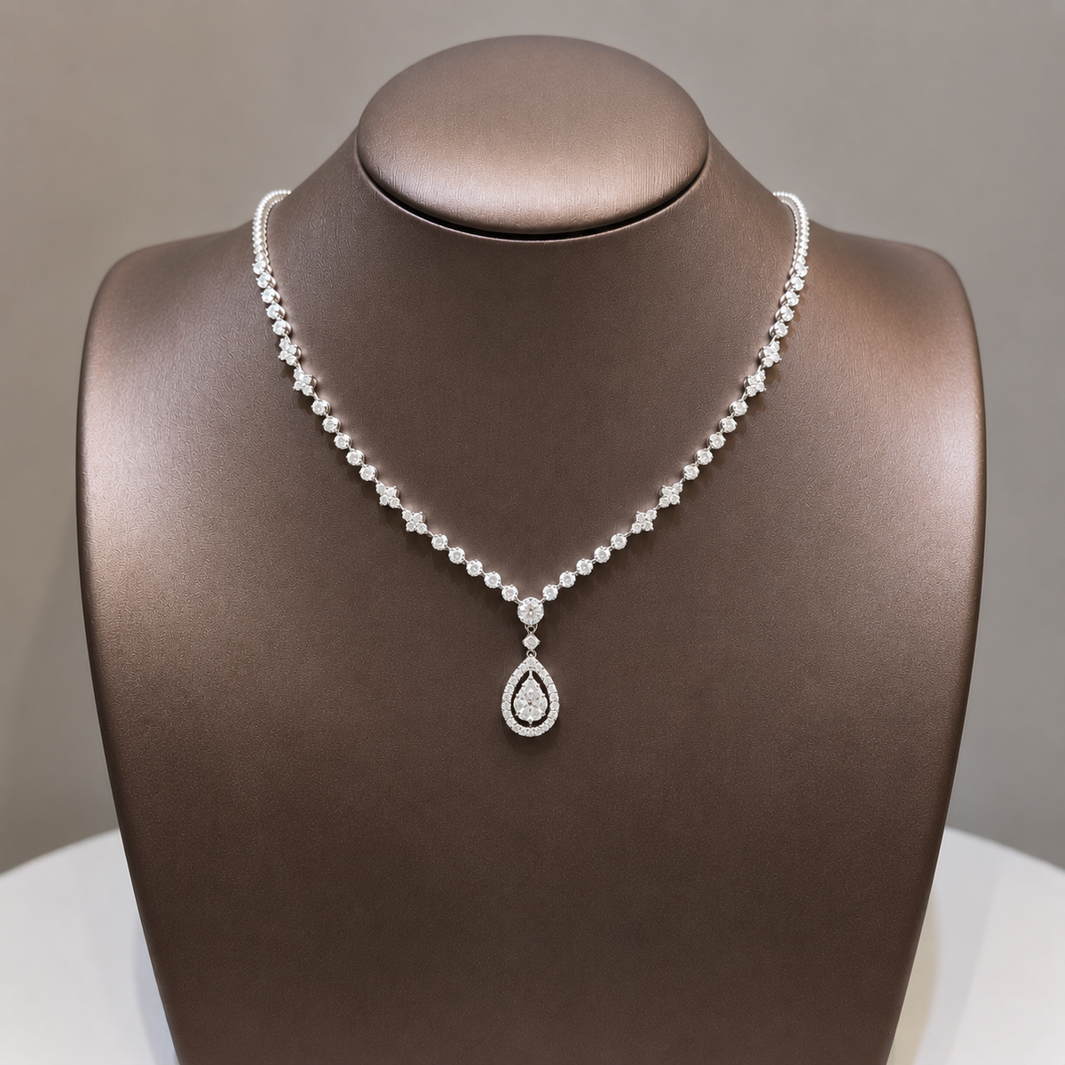 The Regal Pear-Aura Diamond Necklace featuring a GIA certified natural pear halo diamond pendant on a luxury V shape diamond necklace crafted in 18K White Gold by S.Diamond Bangkok Thailand