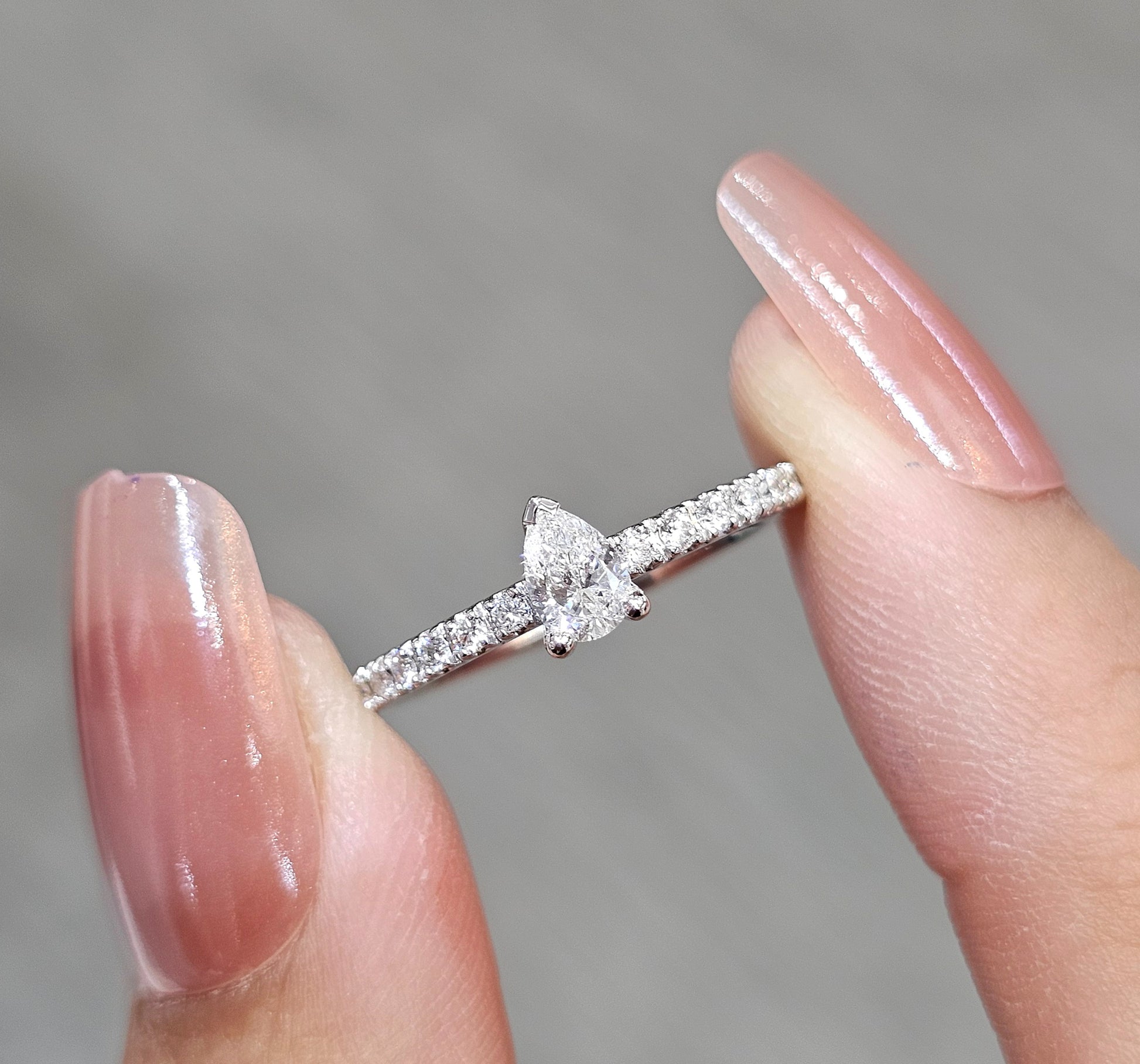 Close-up Pear Cut diamond engagement ring with pavé diamond band by S.Diamond