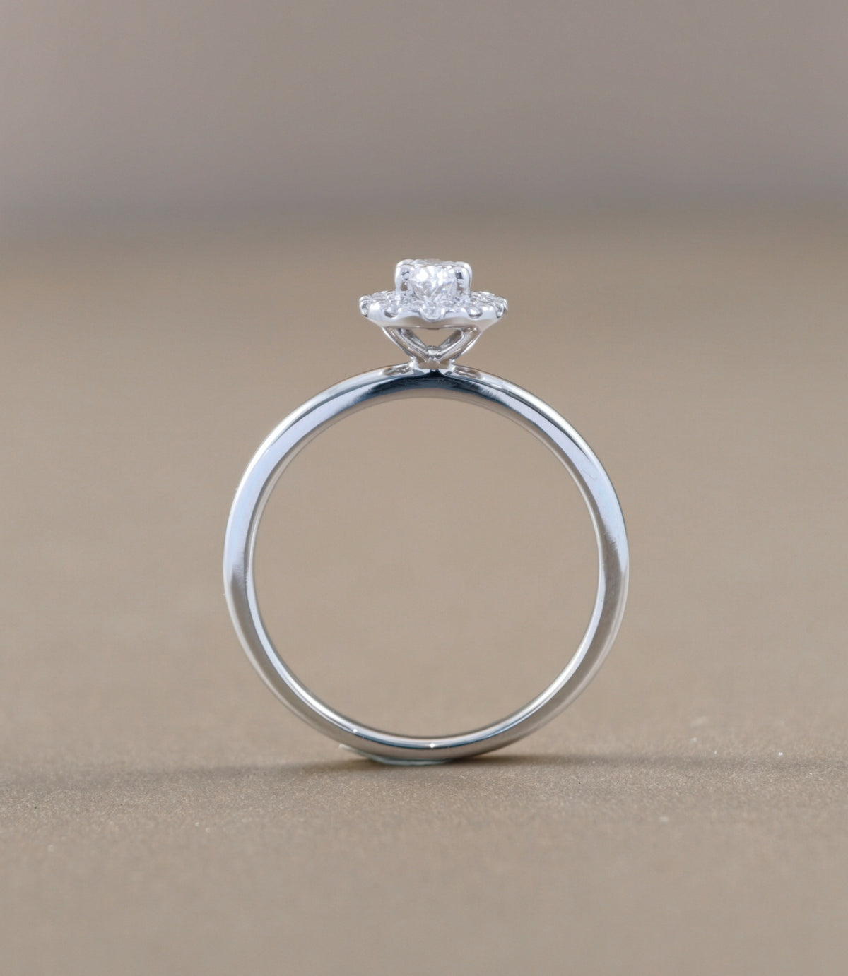 A white  engagement ring with a oval -cut diamond center stone 
