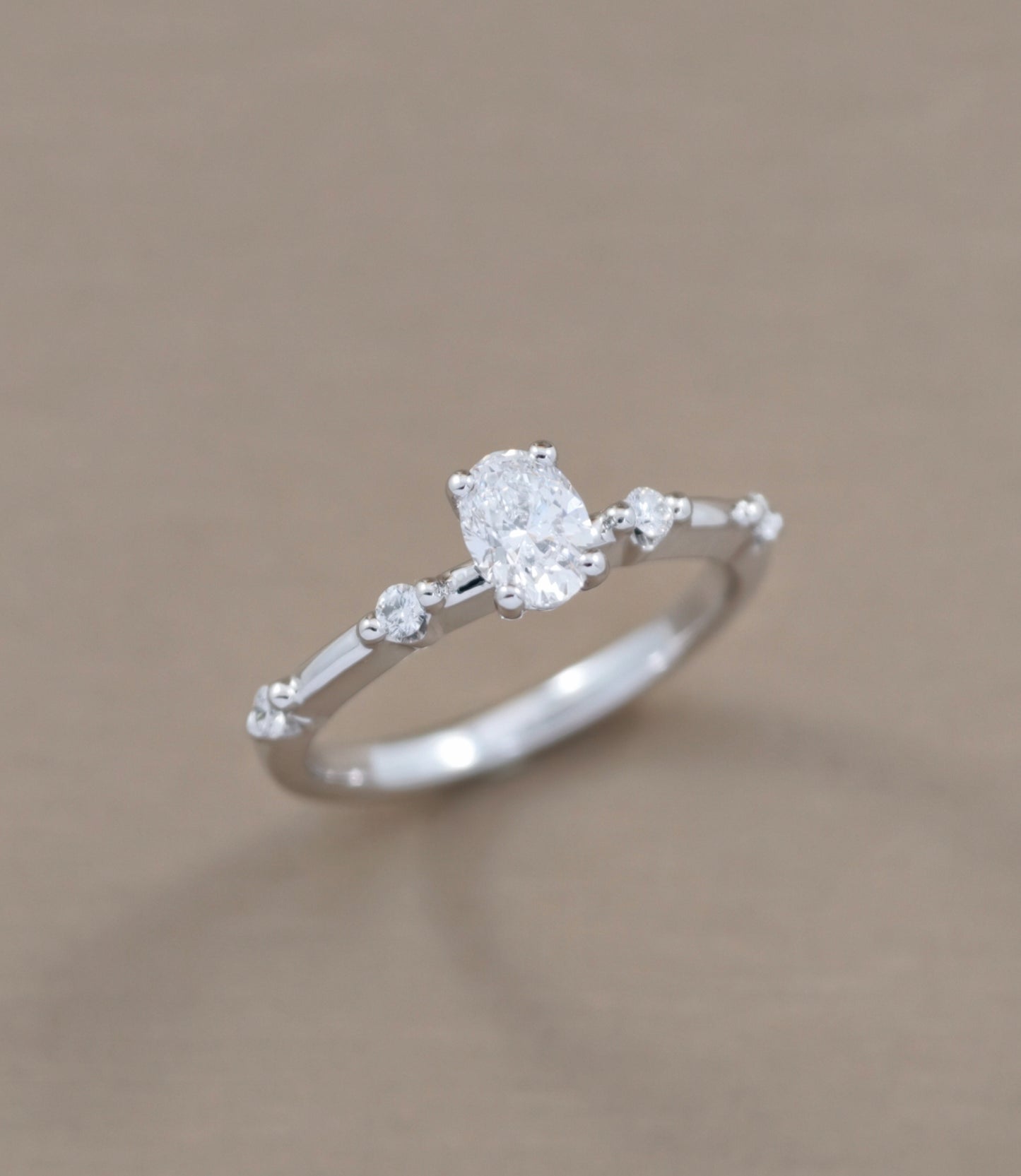 Oval Cut diamond engagement ring with graduated side diamond accents angled view by S.Diamond