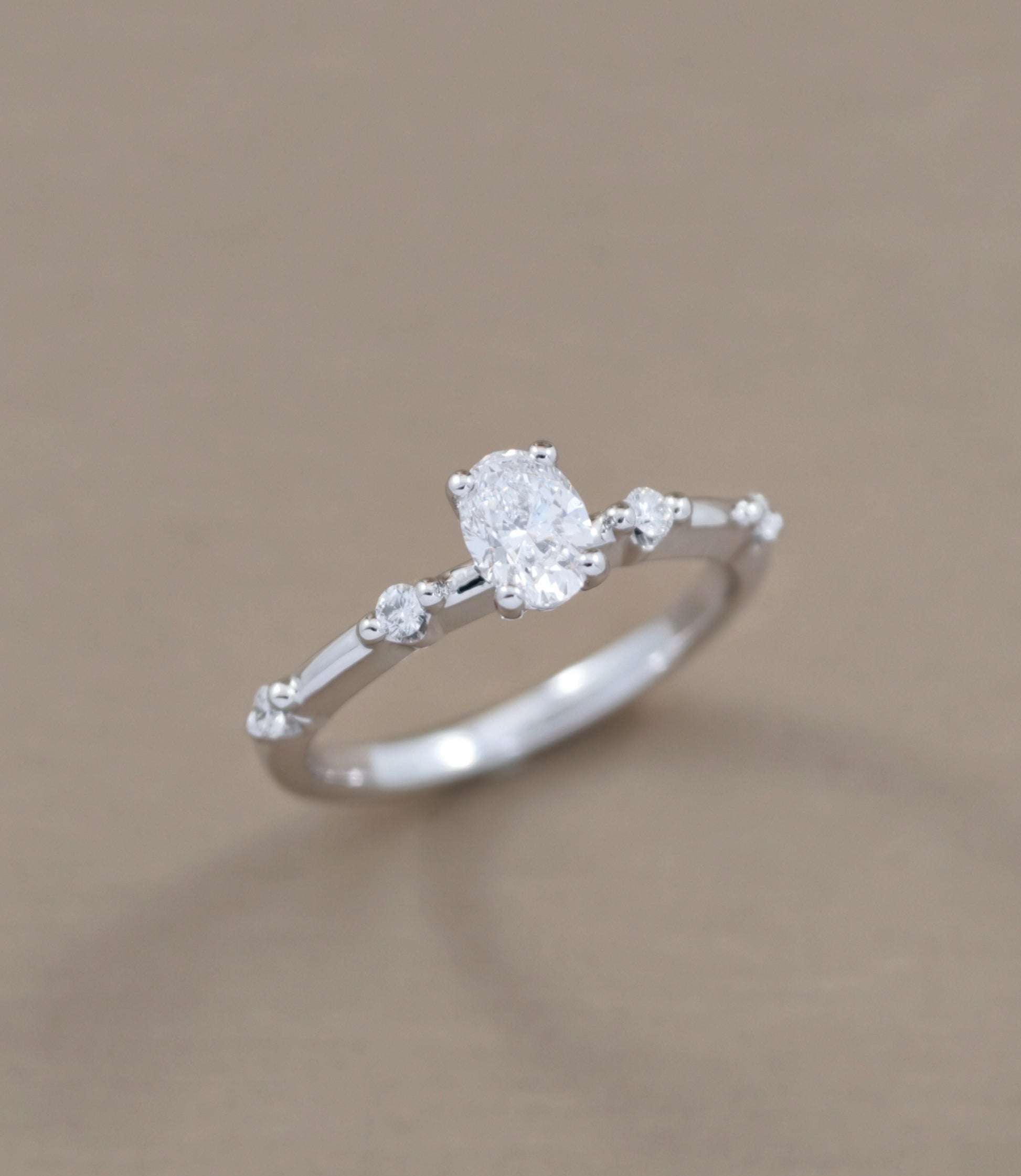 Oval Cut diamond engagement ring with graduated side diamond accents angled view by S.Diamond