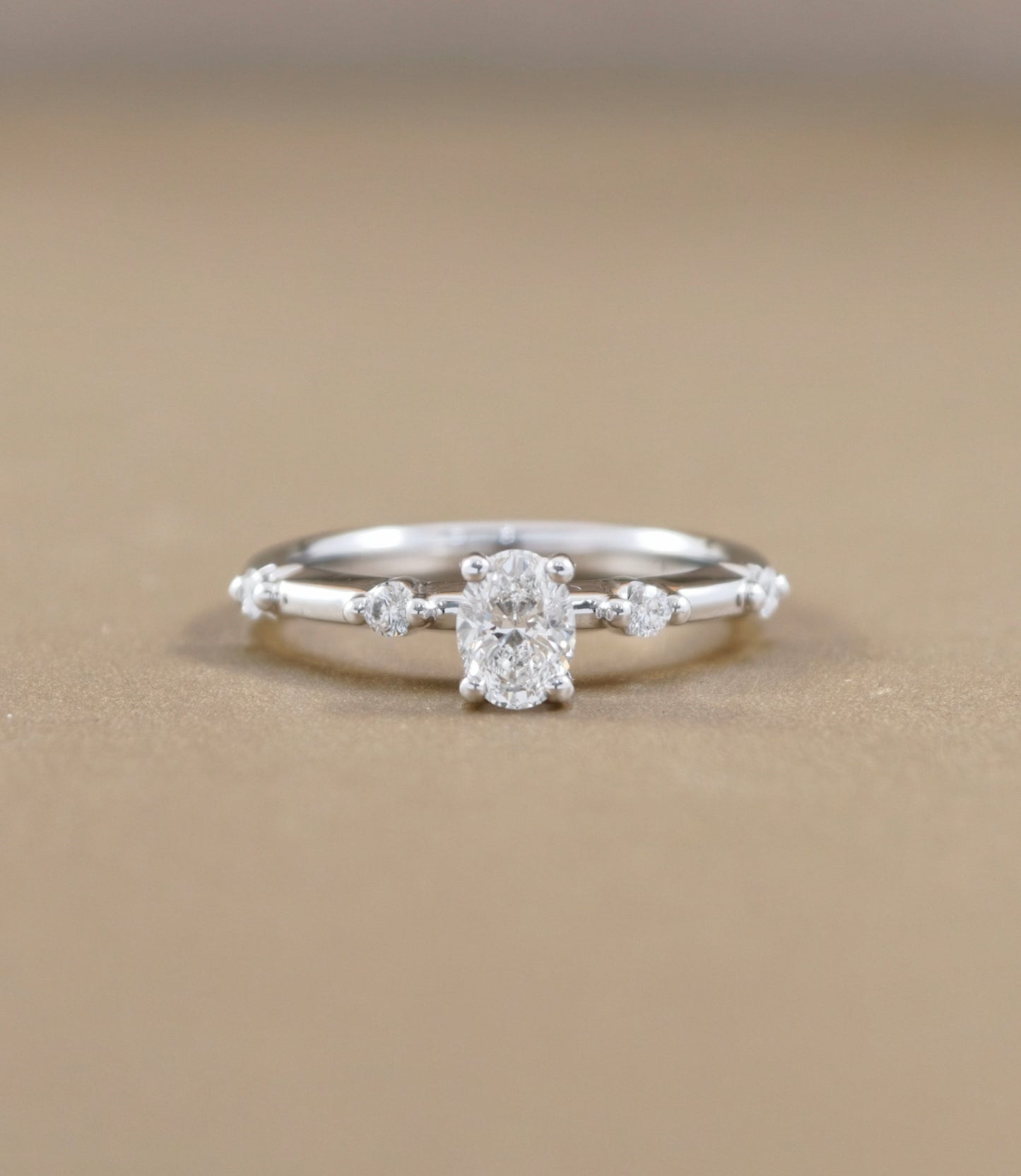 Oval Cut natural diamond graduated side-stone engagement ring in white gold by S.Diamond Bangkok