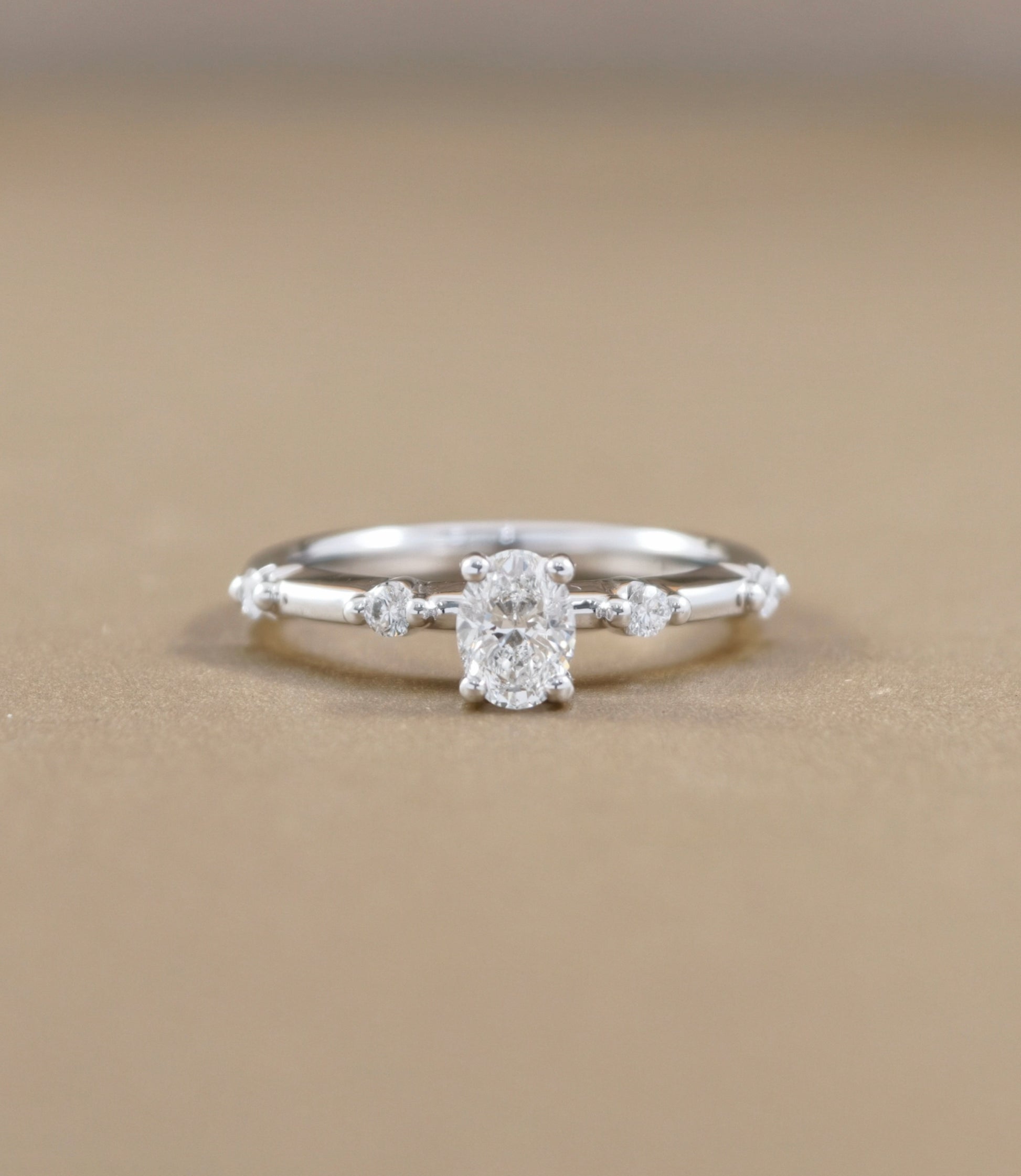Oval Cut natural diamond graduated side-stone engagement ring in white gold by S.Diamond Bangkok