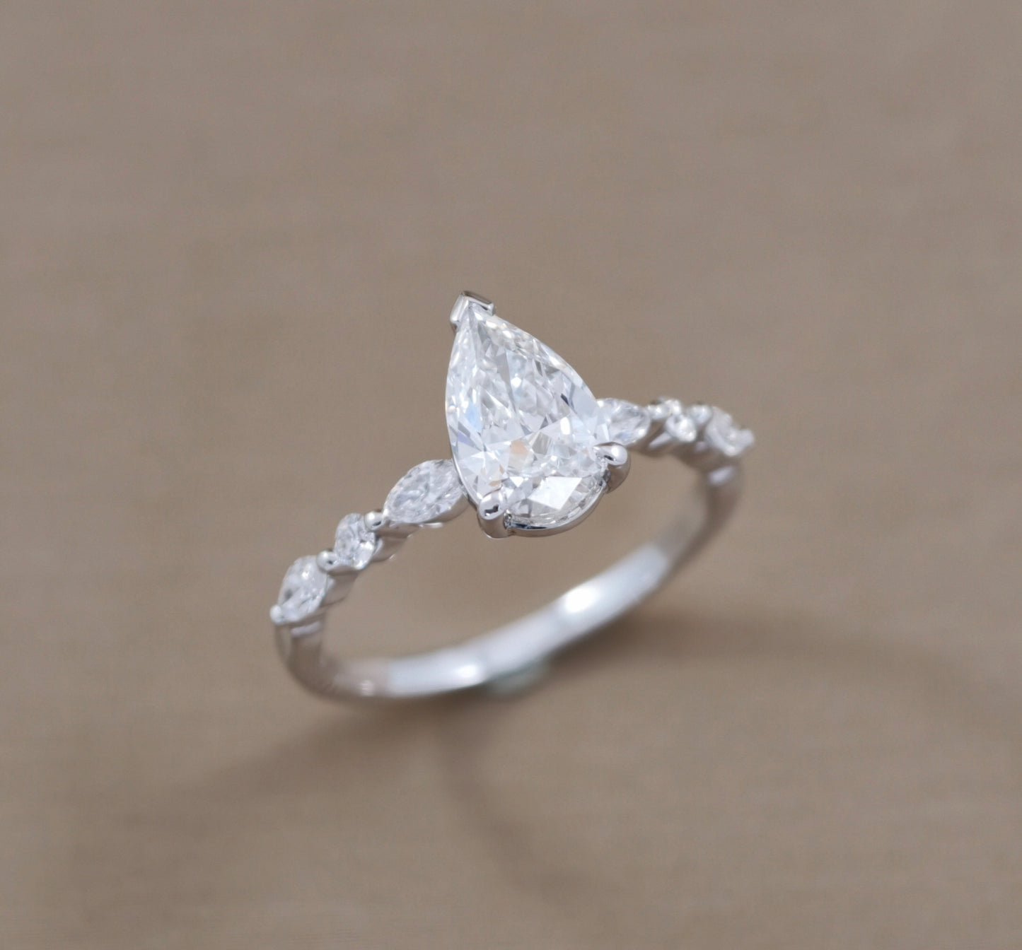 Pear Cut natural diamond engagement ring with Marquise side diamonds try-on by S.Diamond Bangkok