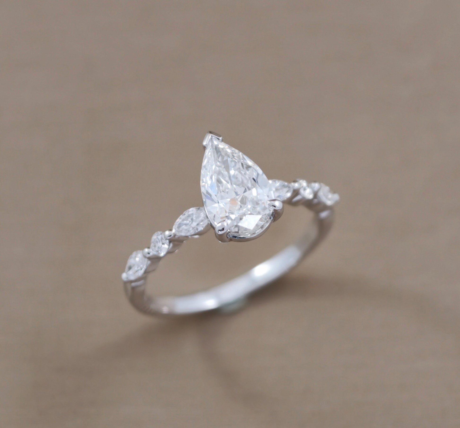 Pear Cut natural diamond engagement ring with Marquise side diamonds try-on by S.Diamond Bangkok