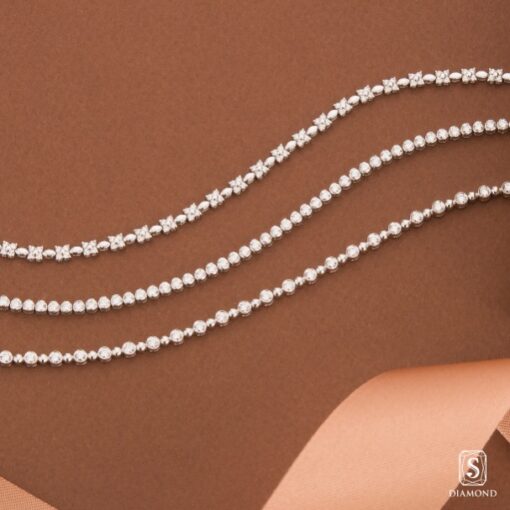 Sweet and petite youthful diamond bracelets set featuring floral four-petal cluster, minimalist tennis, and beaded station designs by S.Diamond