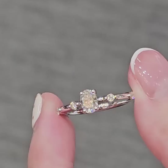 Oval Cut Diamond Graduated Side-Stone Engagement Ring