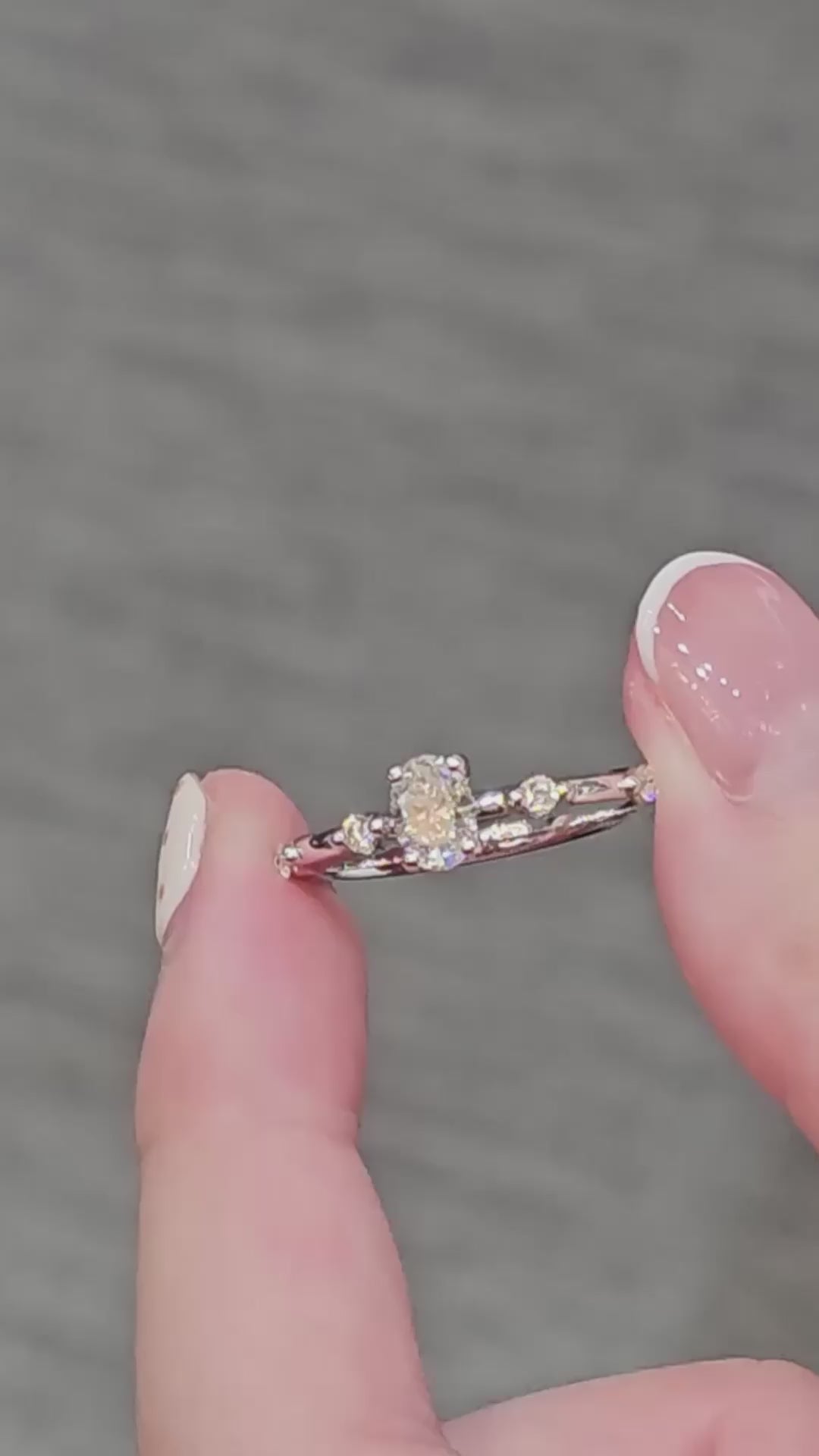 Oval Cut Diamond Graduated Side-Stone Engagement Ring